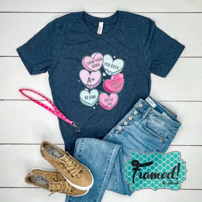 Charcoal tshirt with 6 colorful teacher themed conversation hearts on the front.