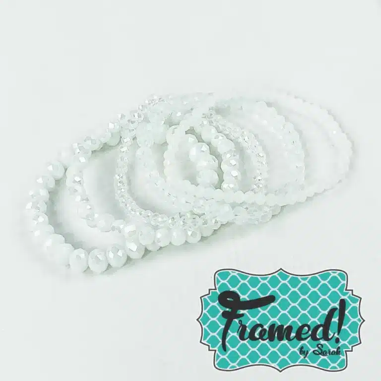 stack of assorted white beaded bracelets with sparkles