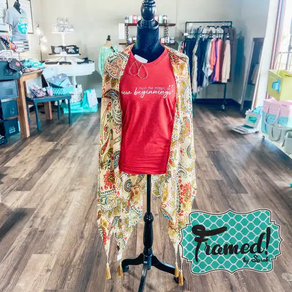 Teal, cream and red paisley kimono with tassels styled over a red "new beginnings" tshirt on a mannequin in a boutique