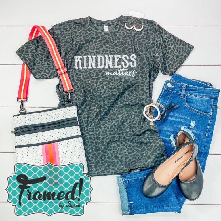 Leopard print Kindness Matters T-shirt Club Tee styled with jeans and a neoprene white and coral crossbody bag