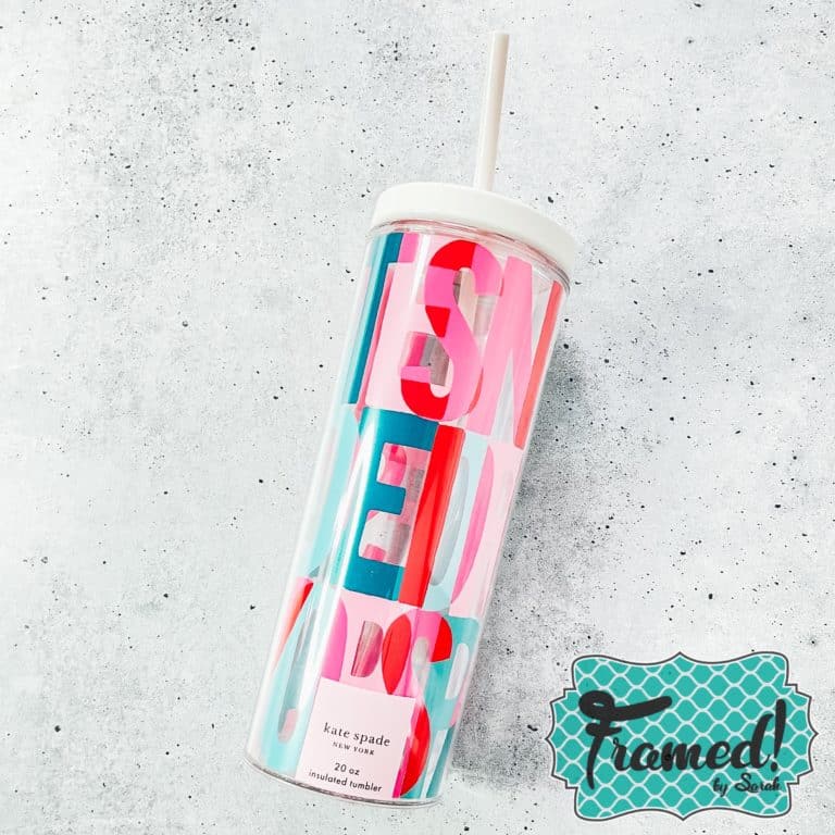 Tumbler with large colorful text print on it staged on a marble surface - August Monogram Box Reveal
