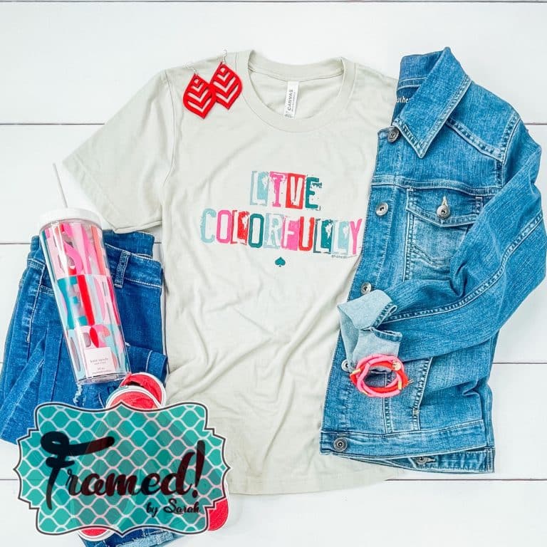 Gray tshirt with multicolored words Live Colorfully styled with a denim jacket red earrings and jeans