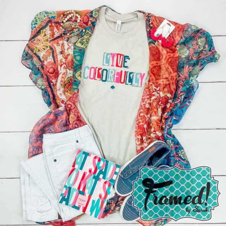 Gray tee shirt with colorful "live colorfully" lettering styled with blue shoes, multi color patterned kimono, and white jeans