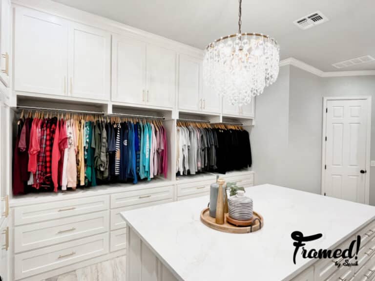 Complete color organized closet from a distance with chandelier