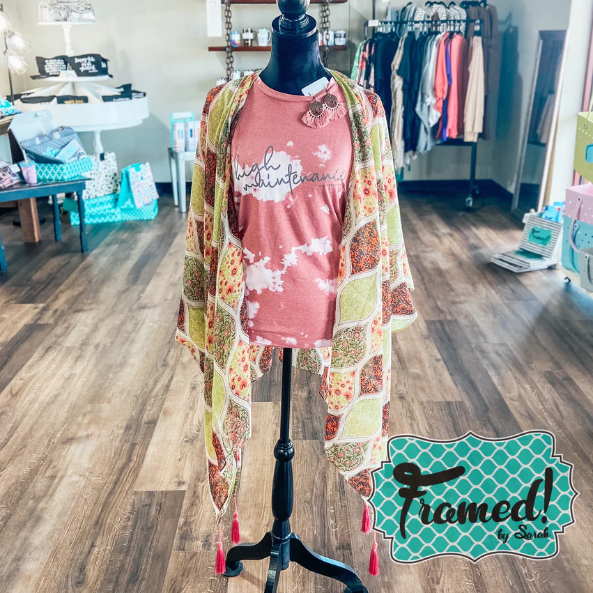 Moroccan tile coral print kimono styled over a coral tshirt on a mannequin in a boutique