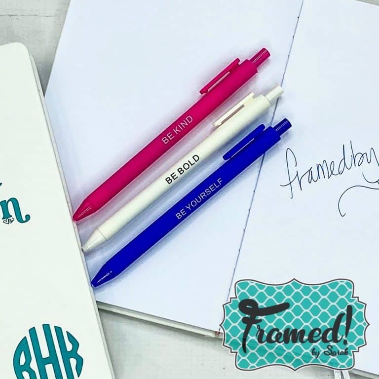 pink white and blue pens on a notebook