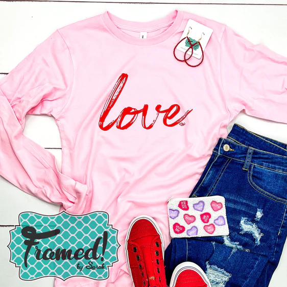 Soft Pink Long Sleeve Love Tee styled with red sneakers and jeans
