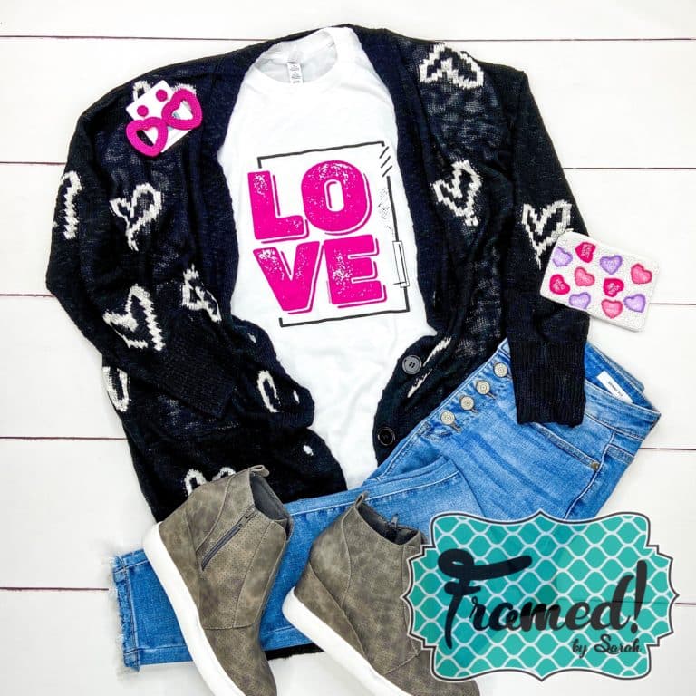 white "love" graphic tee styled with jeans and cozy black and white heart cardigan