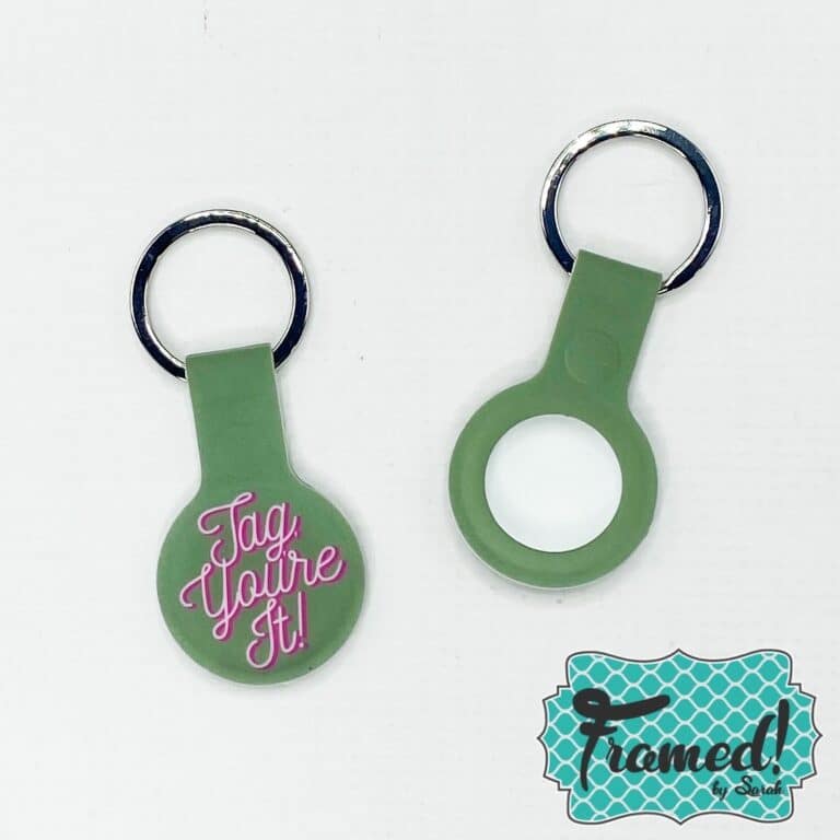 green AirTag keyring with the words Tag You're It in pink font