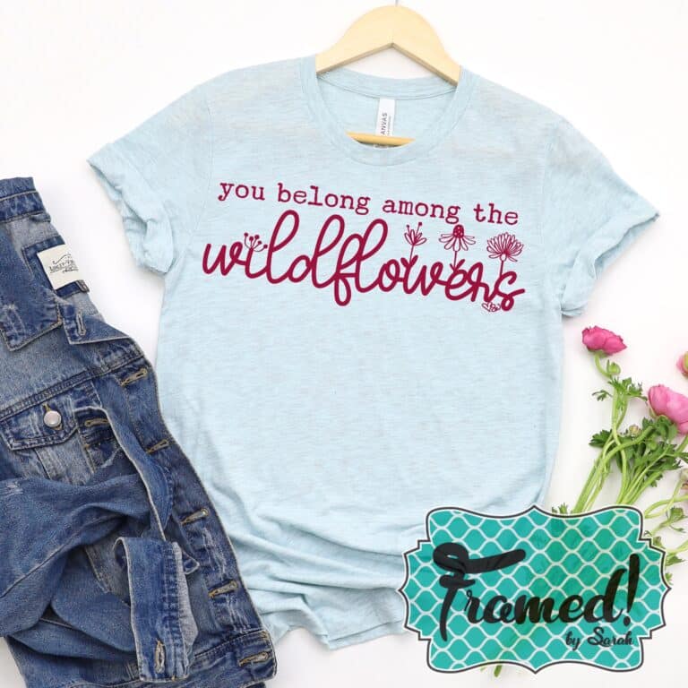 Blue tshirt with pink words that say "you belong among the flowers" March 2023 T-Shirt Club tee