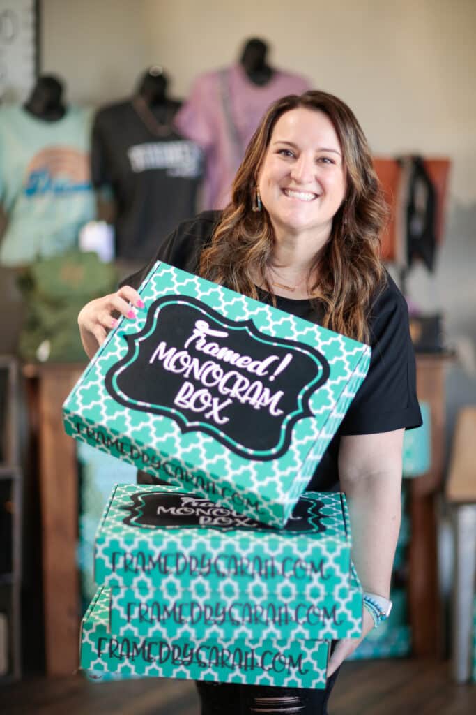 Sarah Williams holding a stack of Monogram Boxes