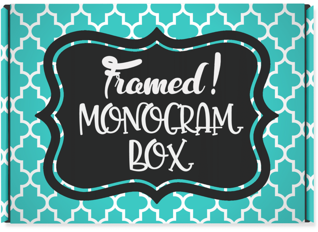 Turquoise and white printed box with a black label "Framed! Monogram Box"