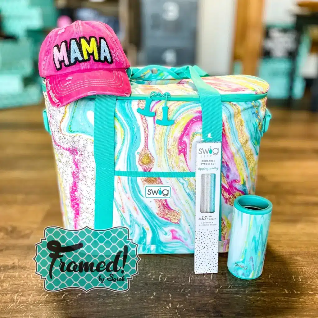 Pink "mama" trucker hat stacked ontop of the colorful printed cooler back
