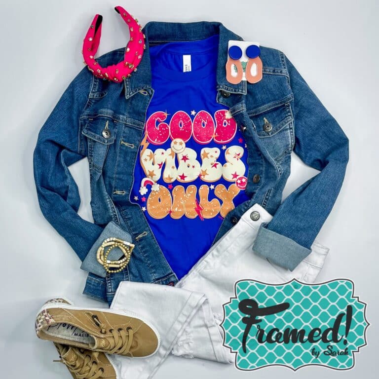 cobalt blue tshirt with pink, white and gold retro words "Good Vibes Only" styled with denim jacket, white jeans, and pink headband
