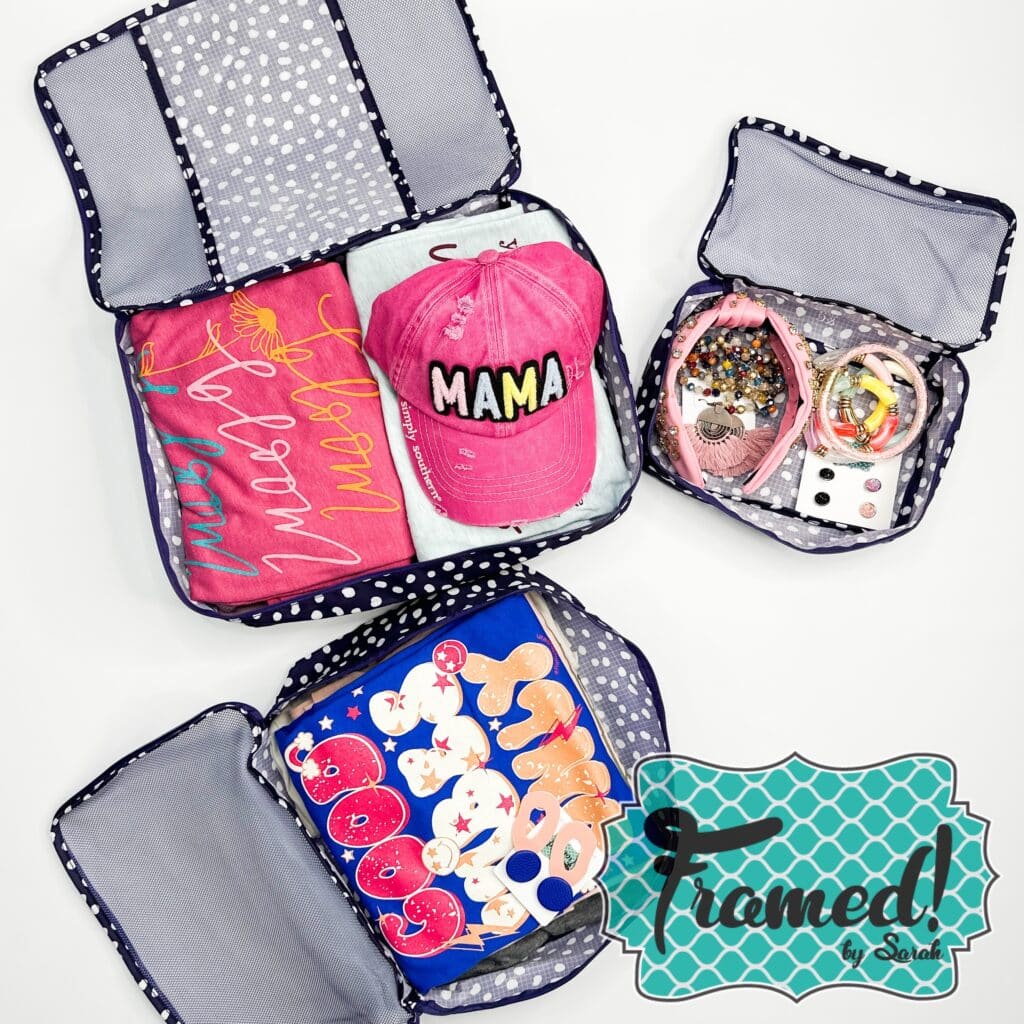 3 piece packing cube set Open full of items. Navy with white polka dots.