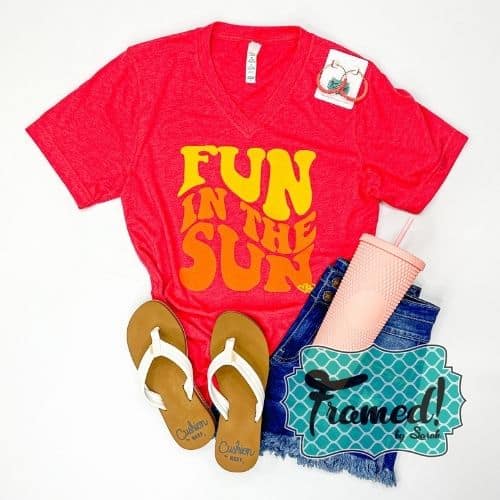 Red "Fun in the Sun" graphic tee styled with cut off denim shorts, white sandals, pink tumbler, and red hoop earrings