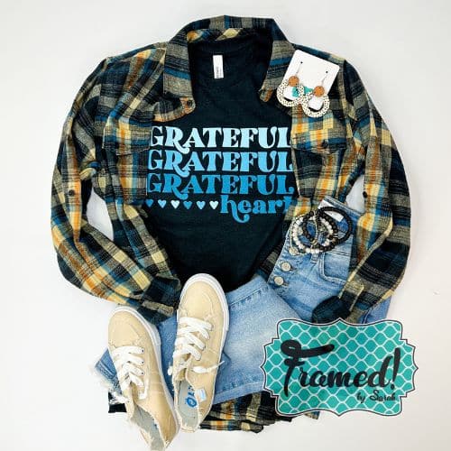 Black tshirts with the words "Grateful Grateful Grateful Heart" styled with plaid button down shirt, white sneakers, and jeans