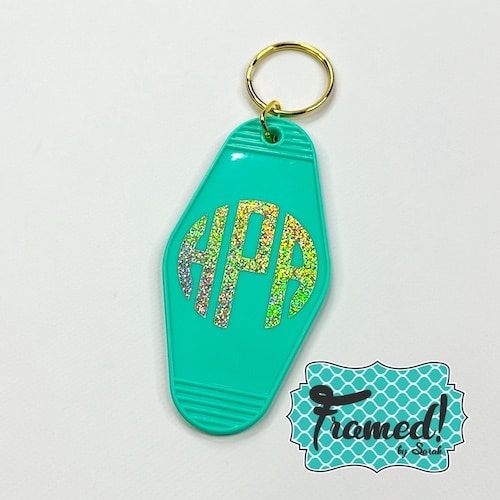 Mint key fob with gold monogram displayed on white background