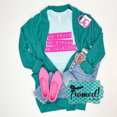 light blue "Be Bold, Be Strong, Be Fearless" text highlighted in hot pink, styled with turquoise cardigan, hot pink ballet flats, and colorful accessories