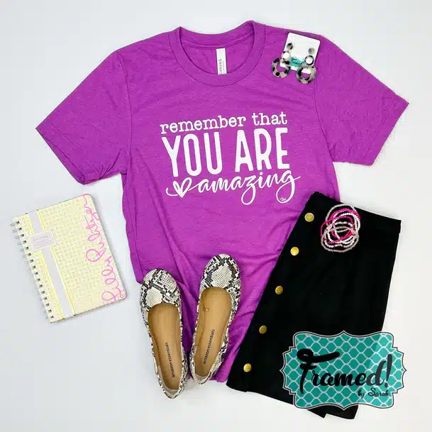 'Remember that You are Amazing' Graphic Tee styled with black skirt, snake skin ballet flats, and a notebook