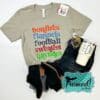 September T-shirt Club Gray shirt with colorful fall words tee styled with dark wash denim jeans, black booties, colorful beaded bracelet stack, red hoop earrings, and ivory monogramed travel cup