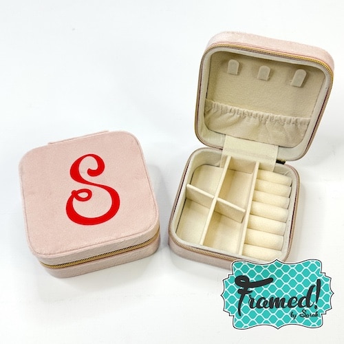 pink jewelry travel case with red monogram