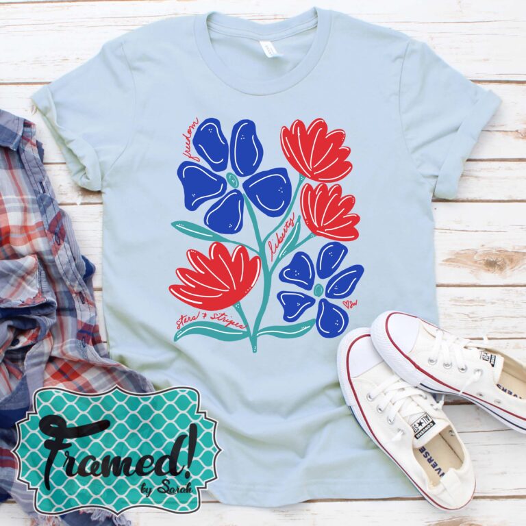 Blue patriotic floral tee styled with white shoes and plaid top. June 2025 T-Shirt Club