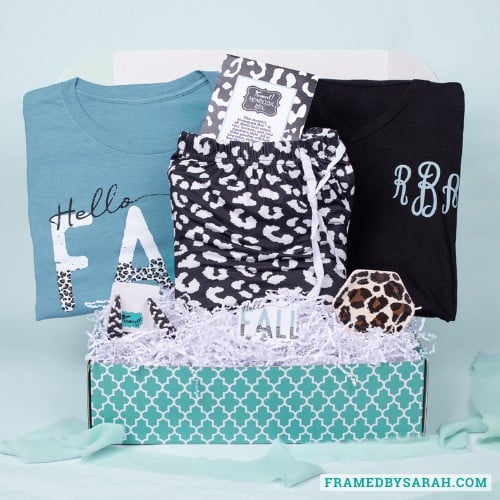 September 2025_Monogram Box displaying all the contents. Contents include: Black monogrammed t-shirt, leopard print pajama pants, leopard print trinket tray, blue "hello fall" tee, and matching earrings.