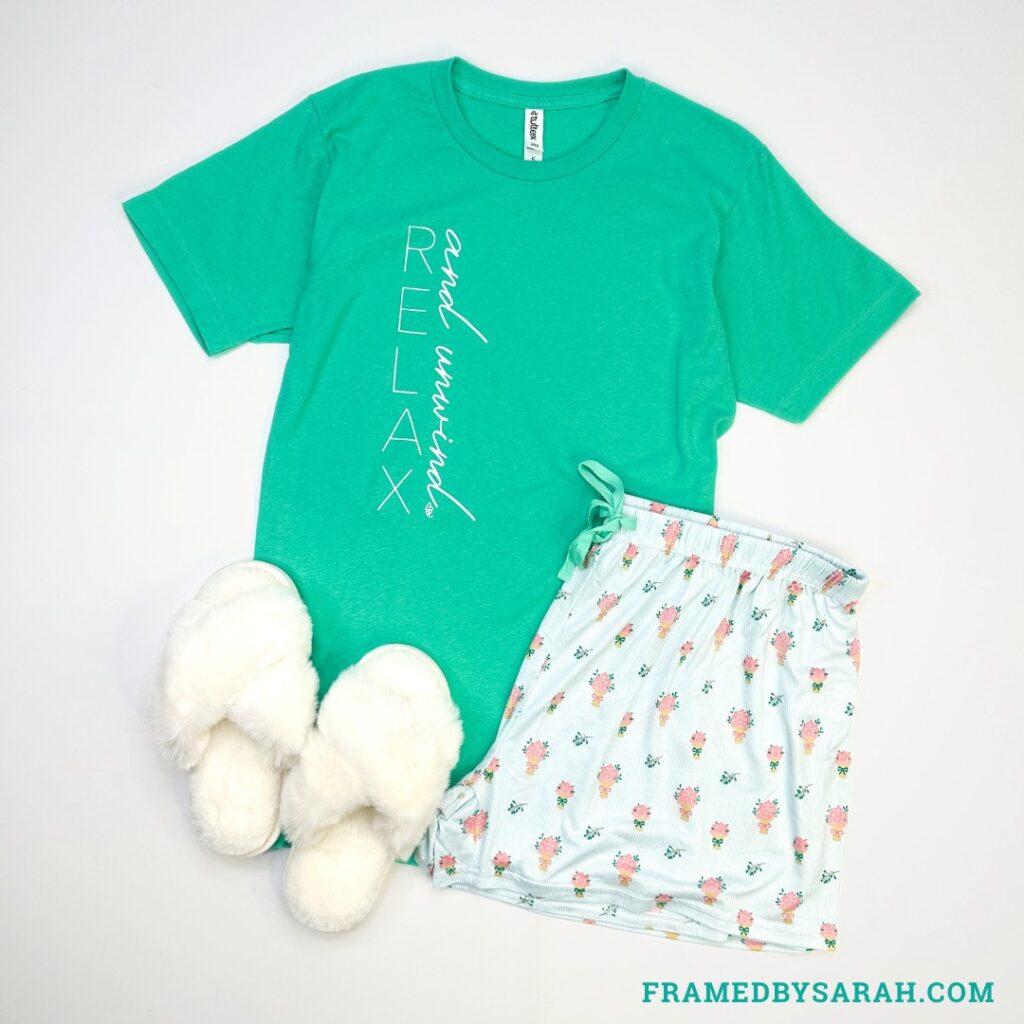 teal "relax and rewind" tshirt, blur floral pajama shorts, and white slippers