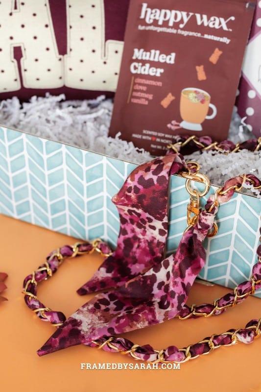 close up of the scarf phone chain inside the teal Framed StyleBox