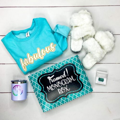 blue "fabulous" sweatshirt, white fluffy slippers, "wildflowers" tshirt, teal beaded bracelets, monogrammed tumbler and a Monogram Box on a white plank floor